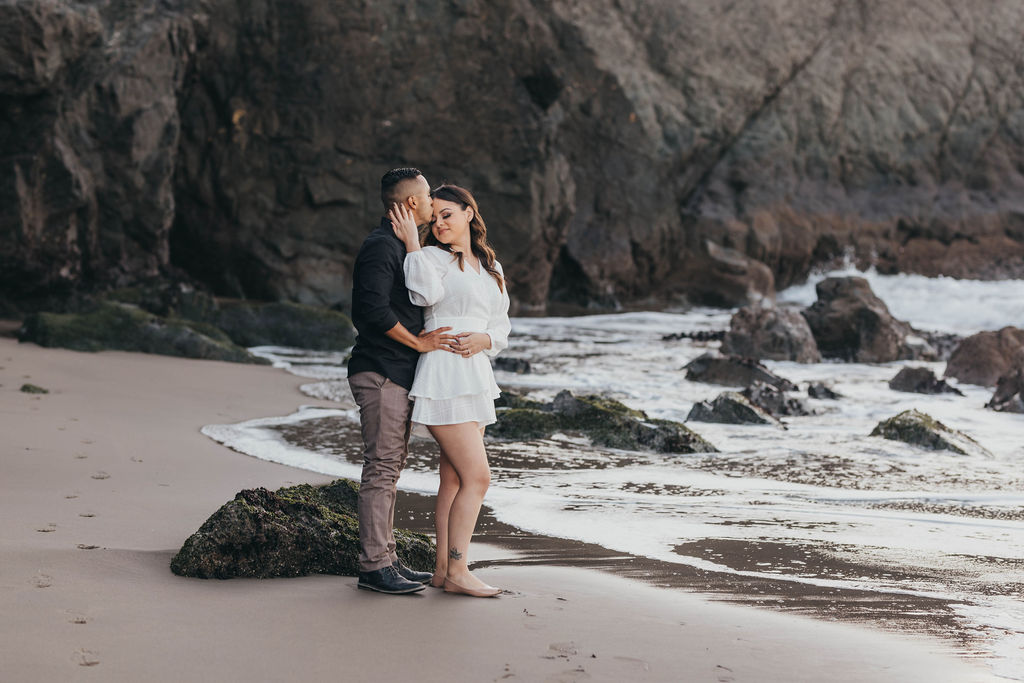 couples posing for photos on china beach in san francisco california