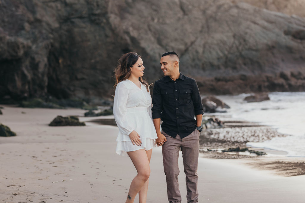 man and woman beach engagement