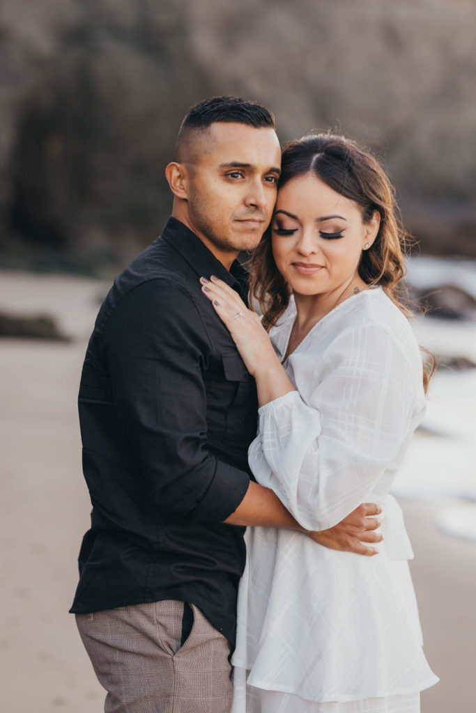 man and woman posing for engagement photos