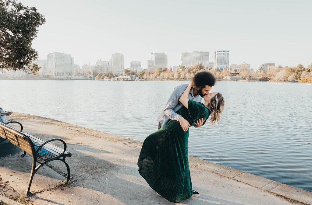 Couple kissing for engagement photos in Oakland CA Merritt Lake
