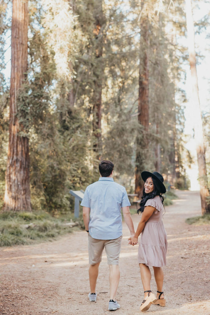 Couple posing for summer engagement photos at T. Elliot Weier Redwood Grove in Davis California University