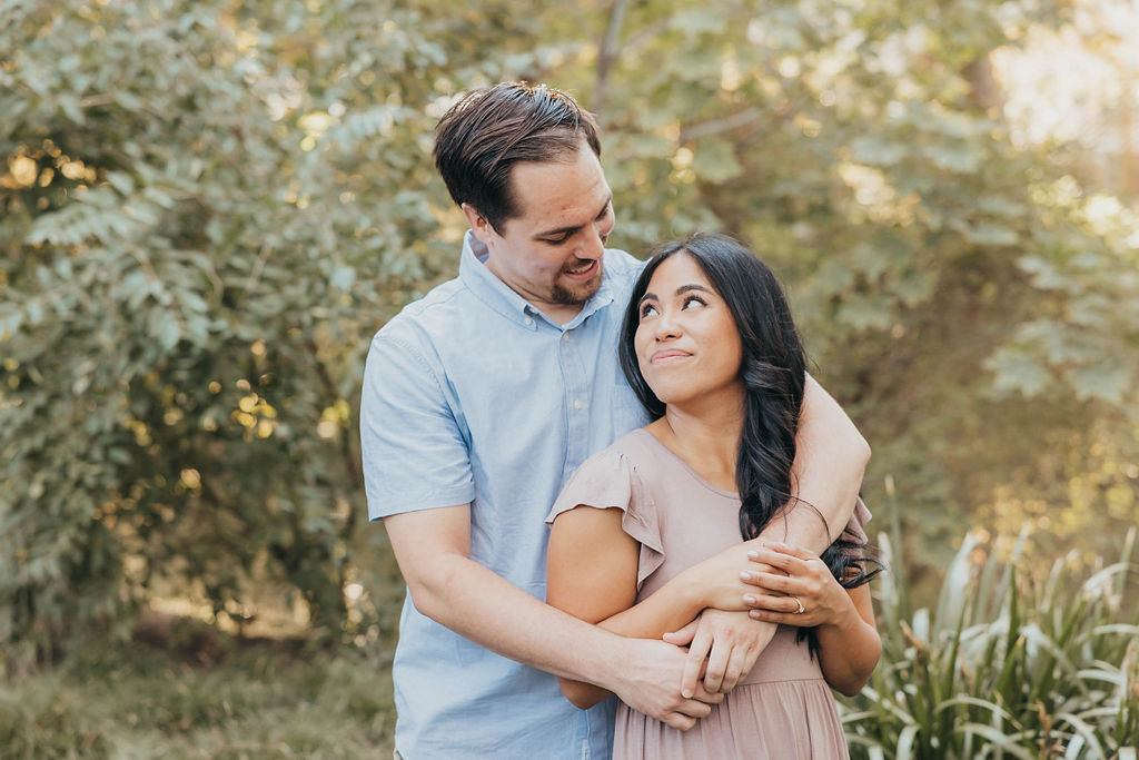 Couple posing for summer engagement photos at T. Elliot Weier Redwood Grove in Davis California University