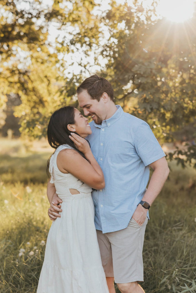 Couple posing for engagement photos at Davis California University gardens