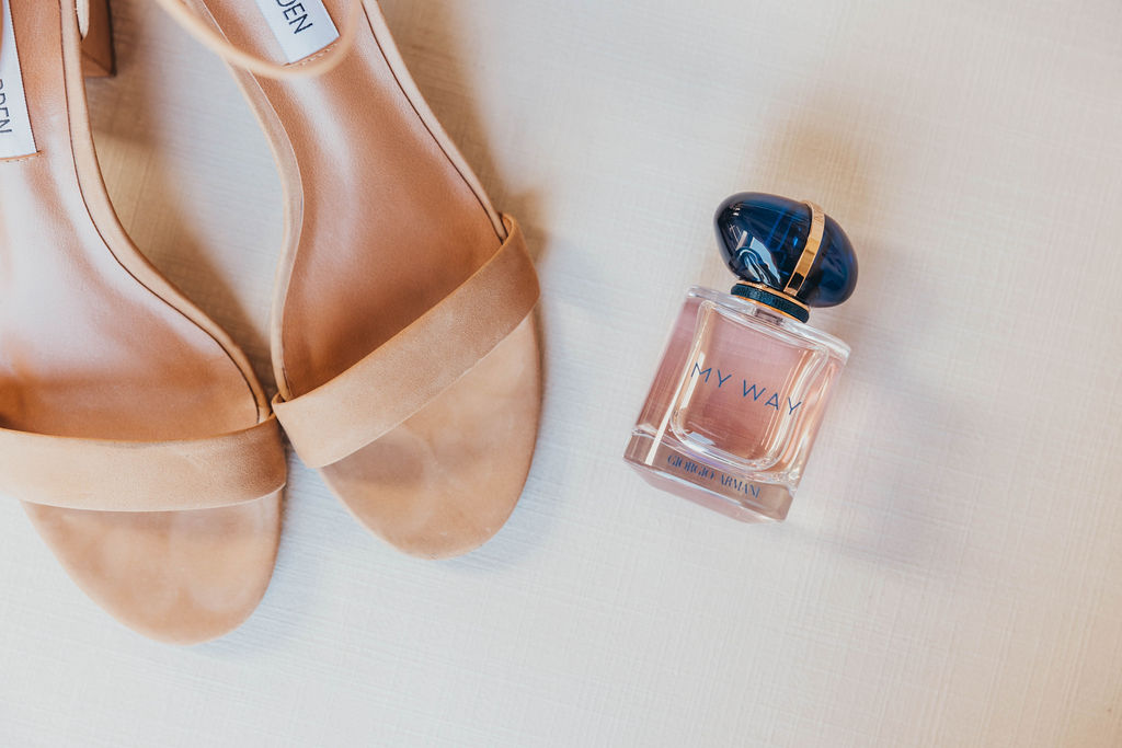 Wedding details with perfume and shoes