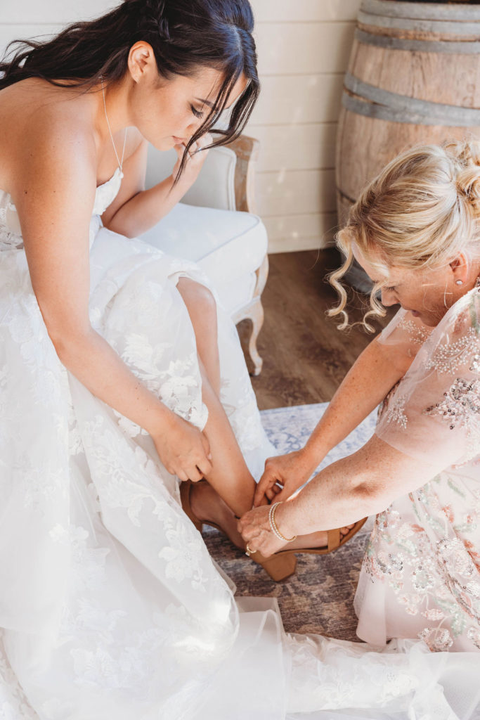 Bride getting shoes put on