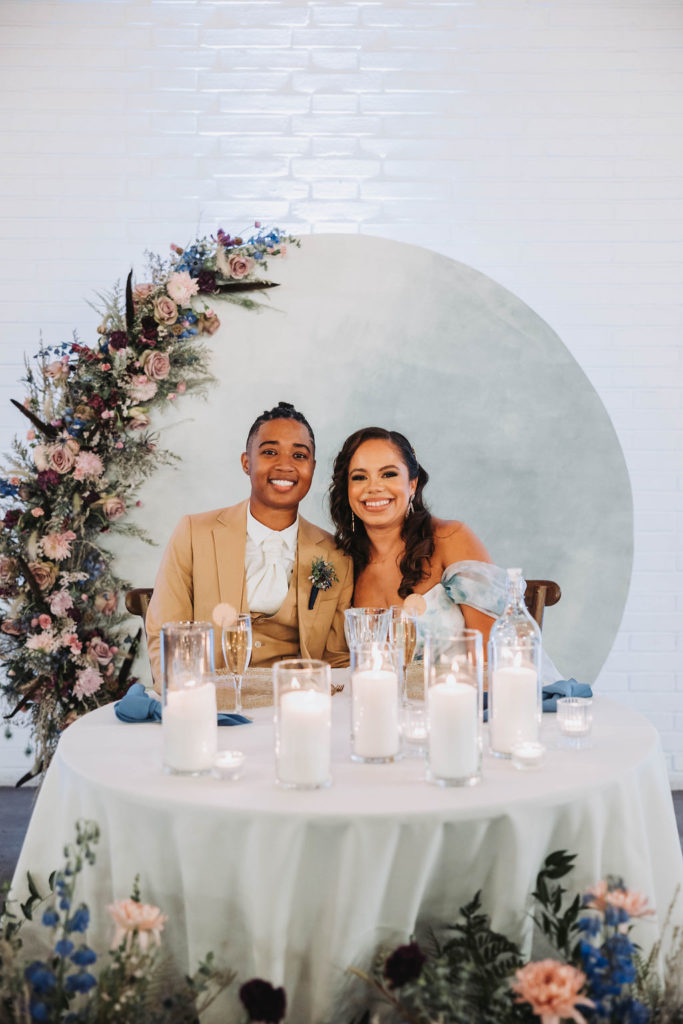 Couple at their reception table during wedding in CA