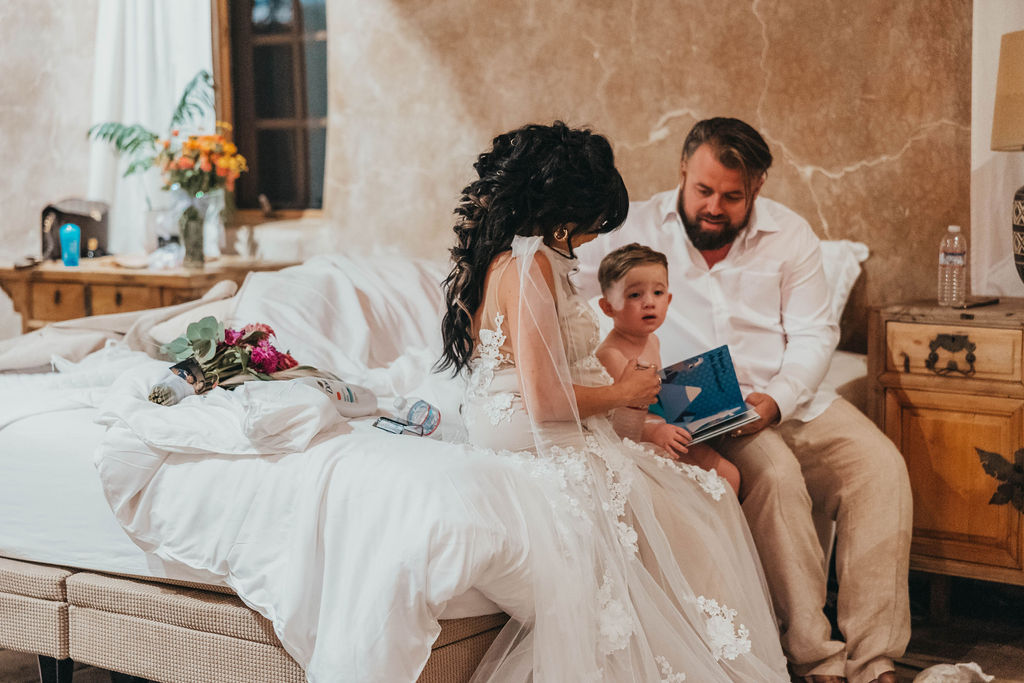 bride and groom reading book to son