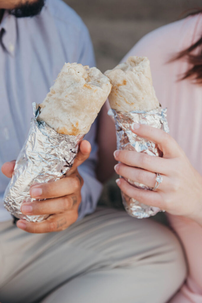 Couple holding burritos
