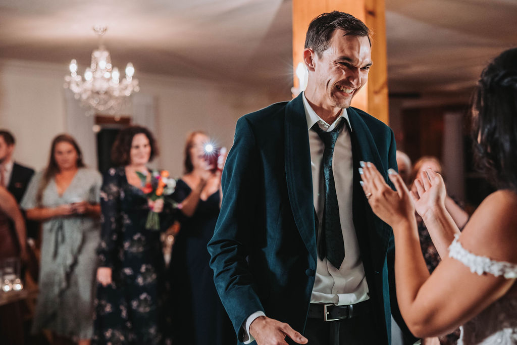 Grooms surprise dance to bride during reception
