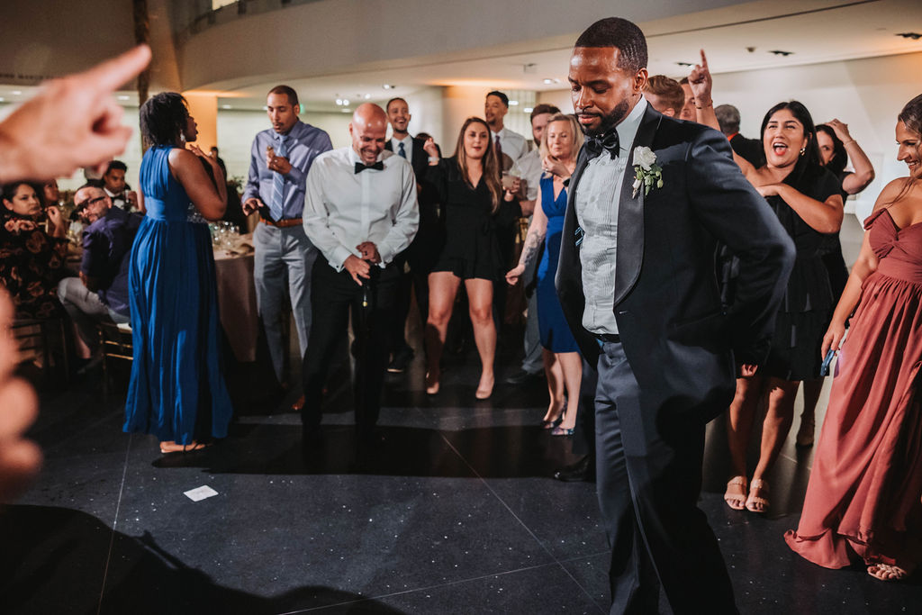 Groom dancing during wedding reception