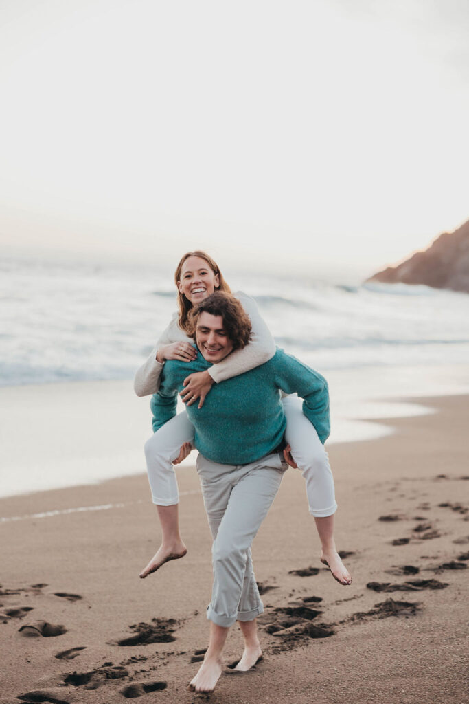 Couples beach engagement photo session at Rodeo Beach Coastal Trailhead