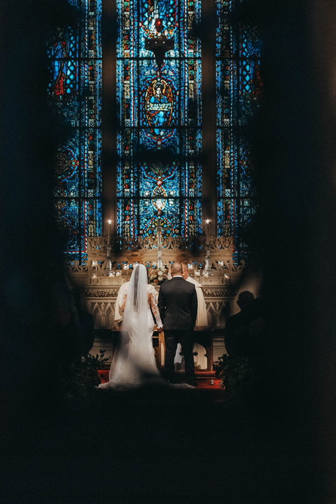 Bride and groom during winter wedding at catholic church