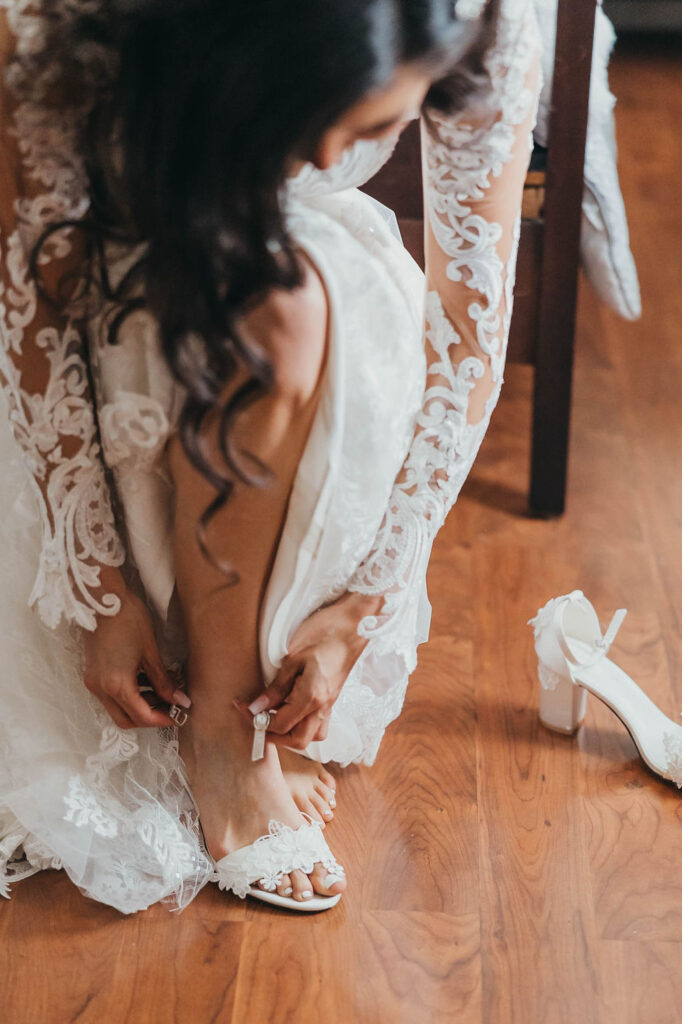 Bride putting wedding shoes on
