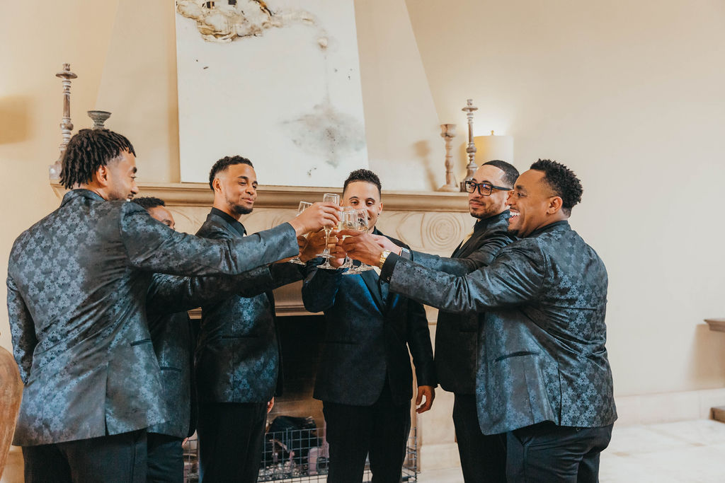 Groom getting ready for wedding with groomsmen