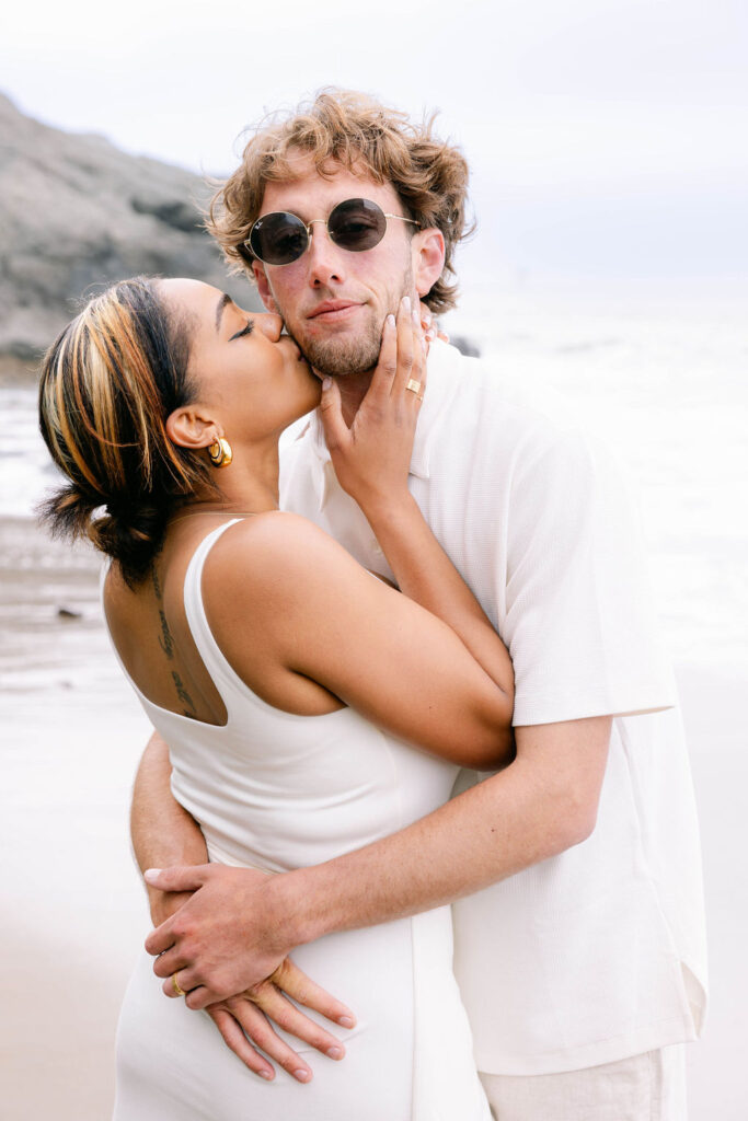 Couple posing for portraits at China Beach