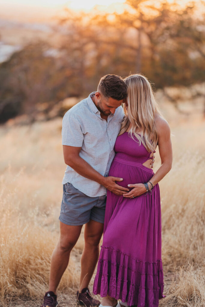 Man and pregnant woman posing for photos