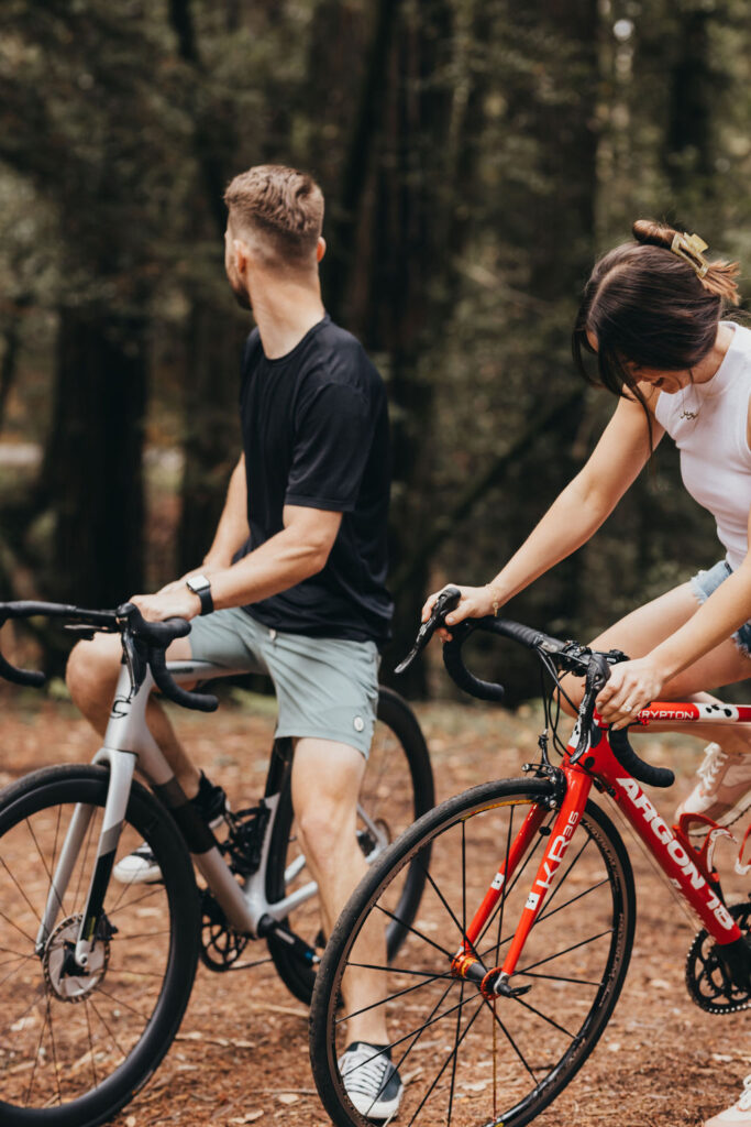 Couple Biking For Adventurous Woodsy Engagement Photos in Northern California