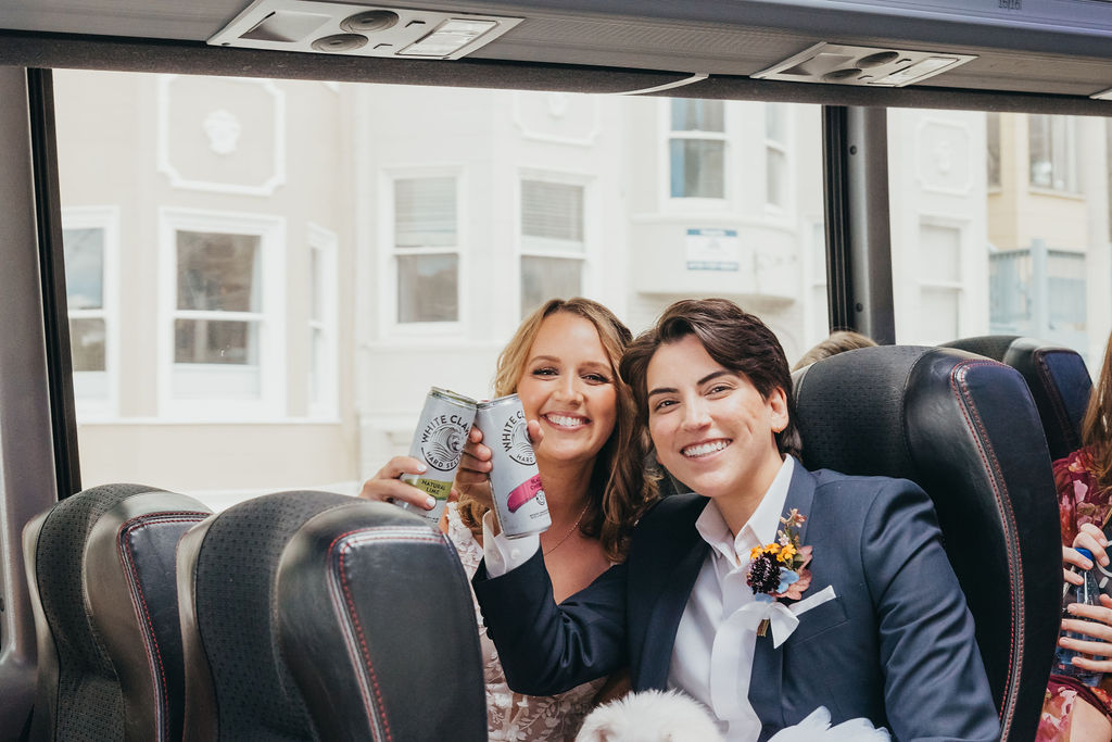 couple toasting drinks on the party bus