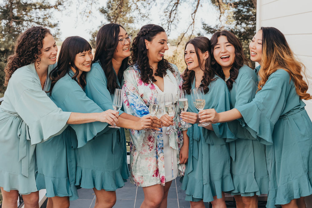 Bride and bridesmaids toasting champagne