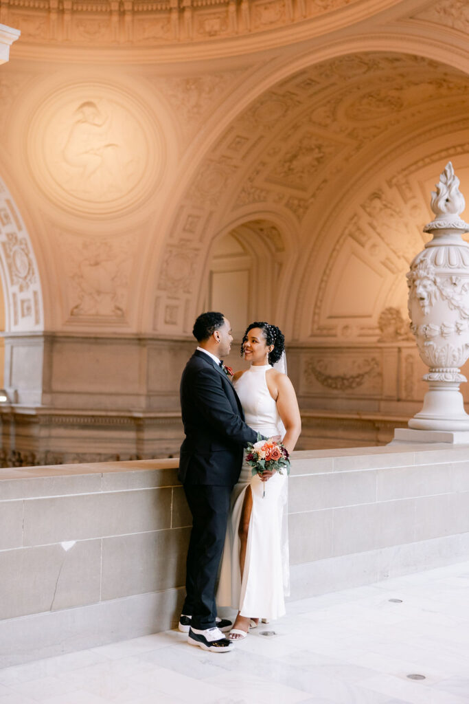 Couple posing for elopement photos at SF City hall