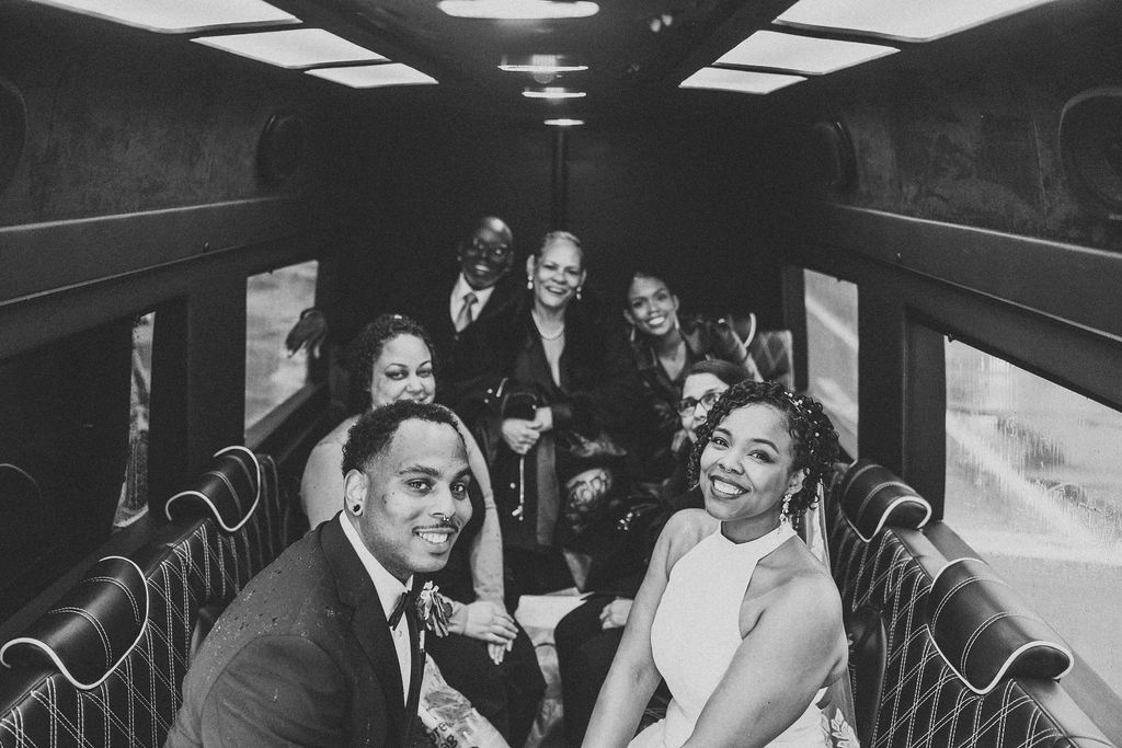 Couple leaving their elopement on a party bus. 