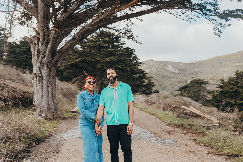 a couple posing and laughing during their seaside couples session