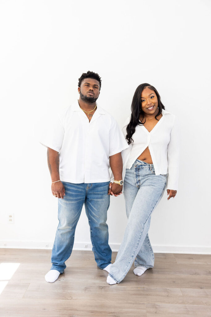 Couple laughing during a relaxed engagement session at Create and Bloom Studios
