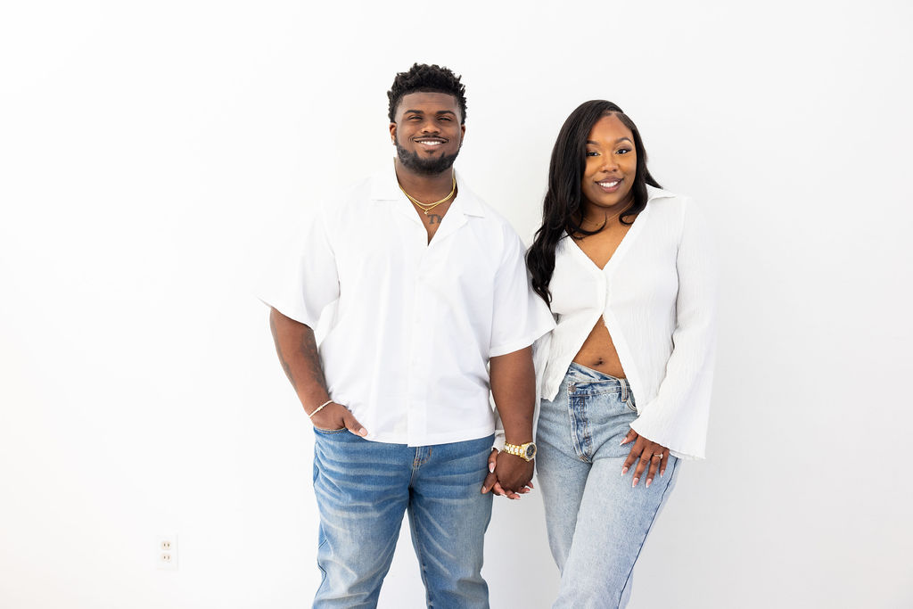 Couple laughing during a relaxed engagement session at Create and Bloom Studios
