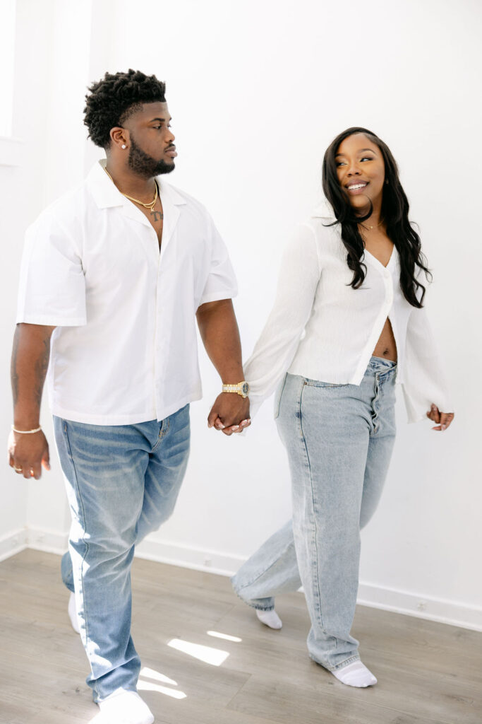 Couple laughing during a relaxed engagement session at Create and Bloom Studios
