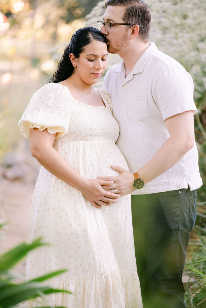 Couple embracing during outdoor maternity photography shoot
