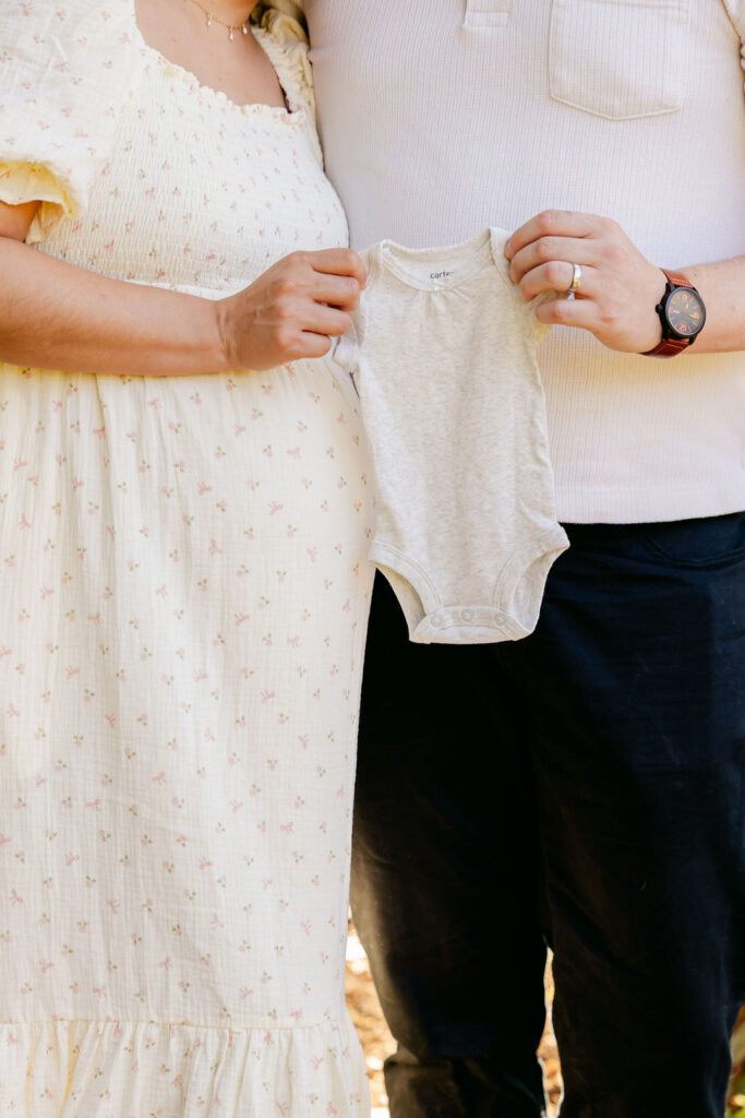 Candid maternity photography showing parents celebrating pregnancy
